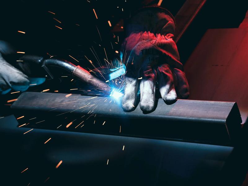MIG welding on a steel weldment, wire feed mid-bead